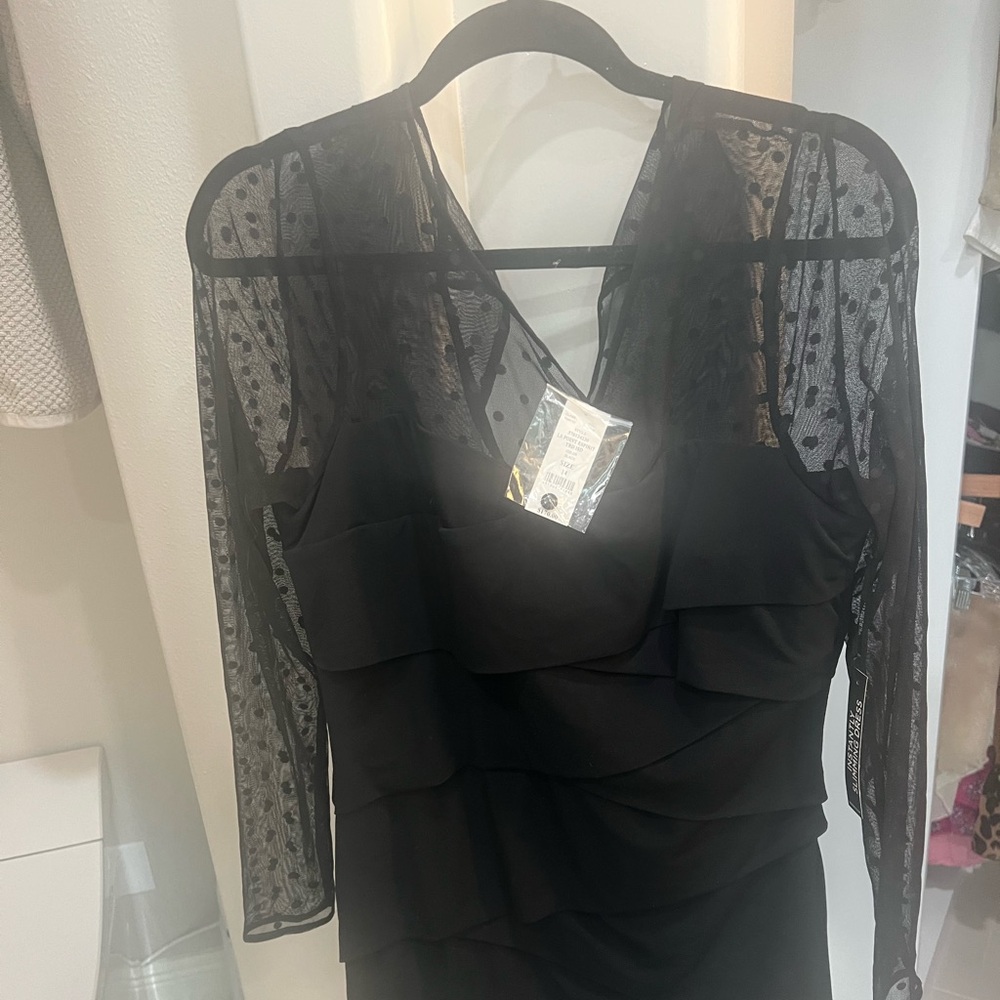 Lovely simple black dress with sheer polka dotted lace arms.